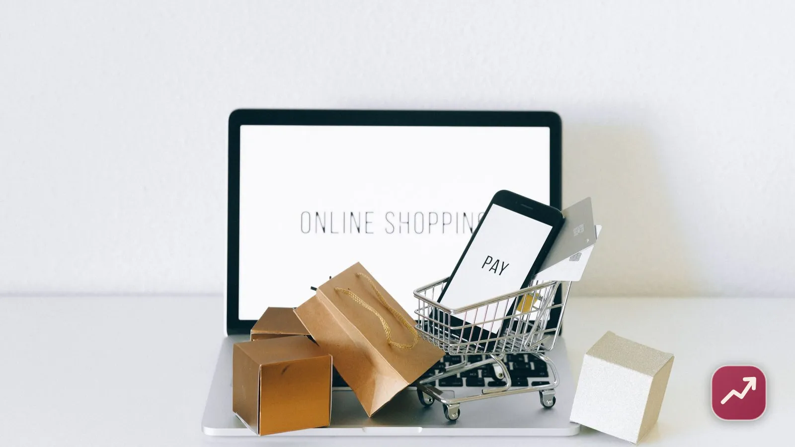 Online shopping on a laptop with a phone showing pay, credit cards and delivery parcels, illustrating how buy now, pay later (BNPL) splits a purchase into installments.