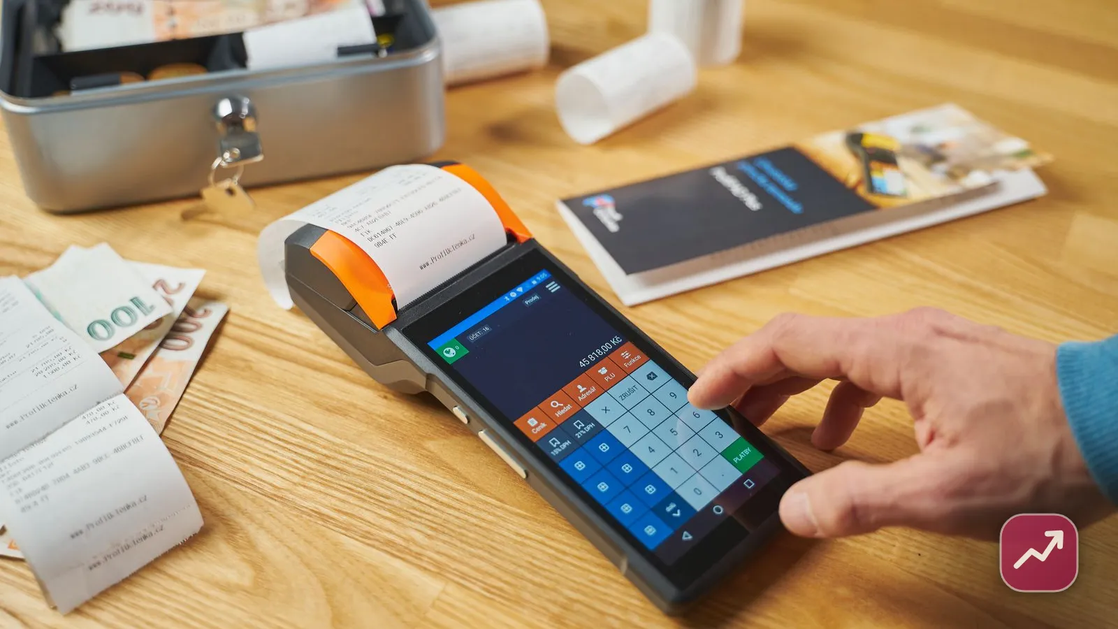 A shop payment terminal with printed receipts and cash on a wooden counter, illustrating how sales tax is charged at the point of sale in the US.