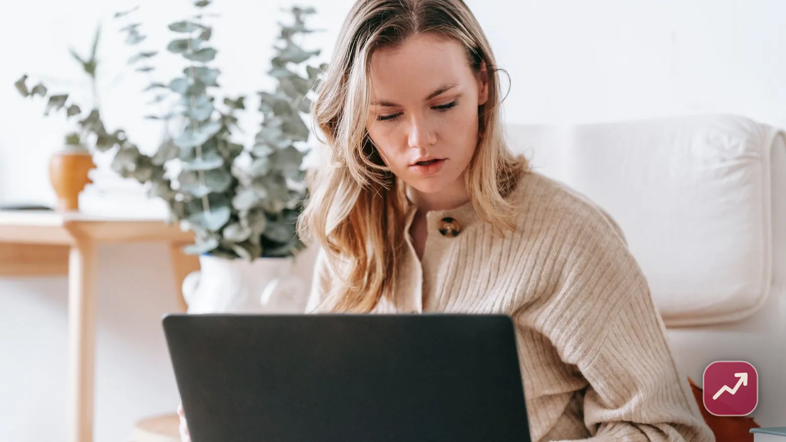 A freelancer working on a laptop in a bright home office, illustrating how to become self-employed and set up a freelance business.
