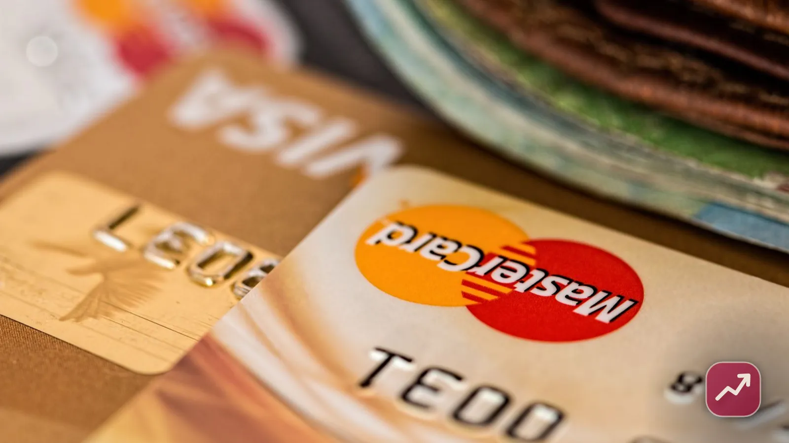 Close-up of bank debit and credit cards fanned out on a desk, illustrating how to choose a bank account and avoid fees.