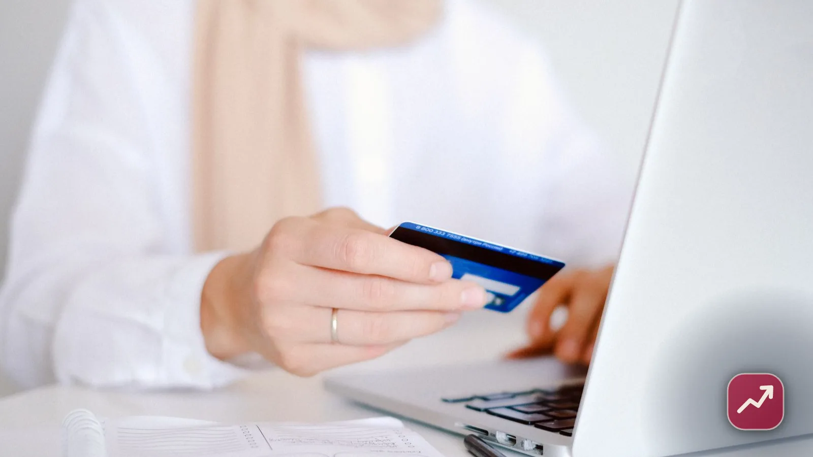 A person reviewing a card statement on a laptop with a credit card in hand, illustrating how to dispute a credit card charge and get a refund.