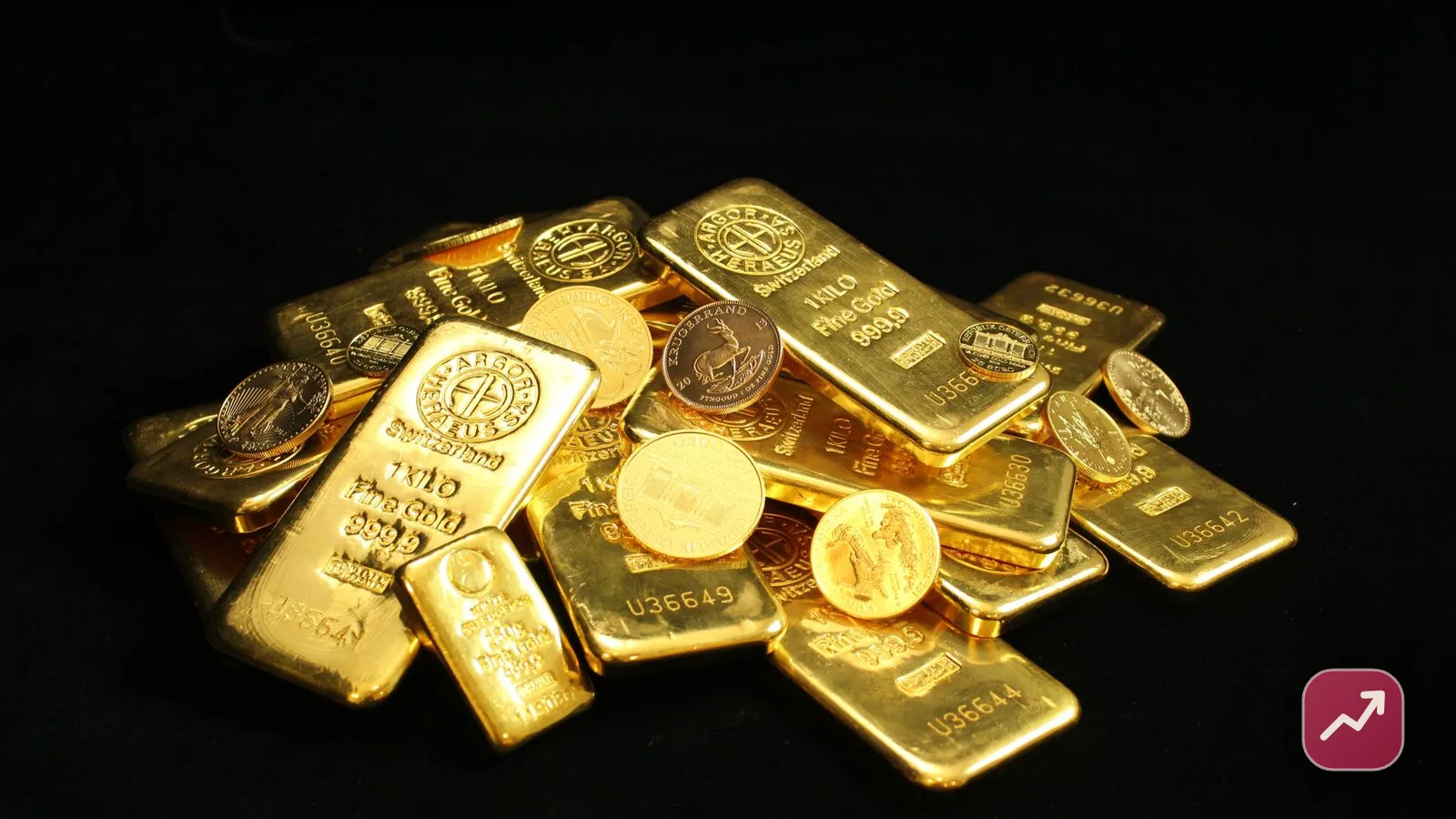 Lingots d’or empilés et pièces d’or sur une surface sombre, illustrant les façons d’investir dans l’or comme l’or physique et les ETC.