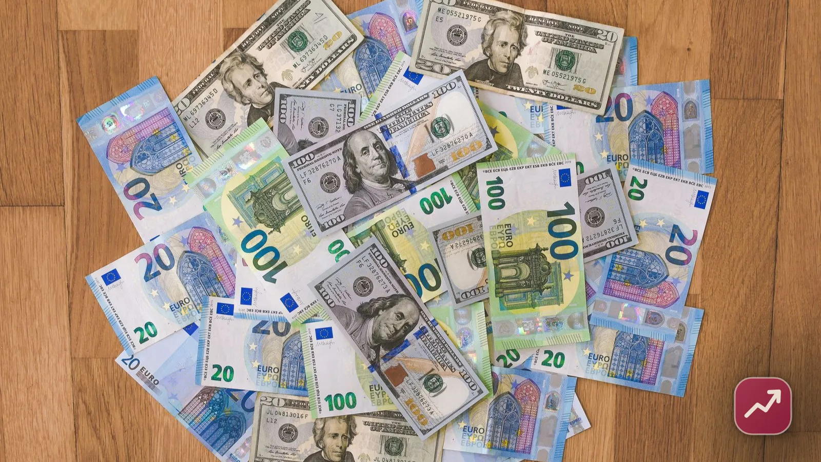 A person sending money abroad on a smartphone banking app next to a world map, illustrating how international money transfers and exchange-rate fees work.