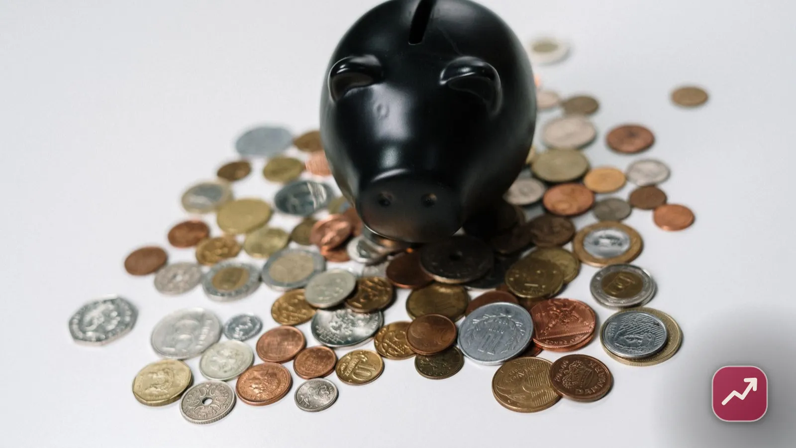 A piggy bank and coins protected under a shield, illustrating whether your money is safe in the bank and how deposit insurance works.